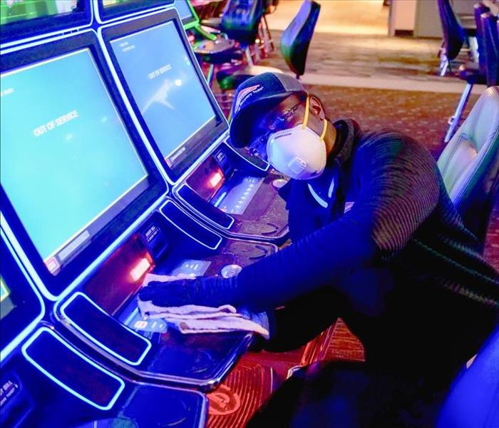SERVPRO employee cleaning the slots at a casino