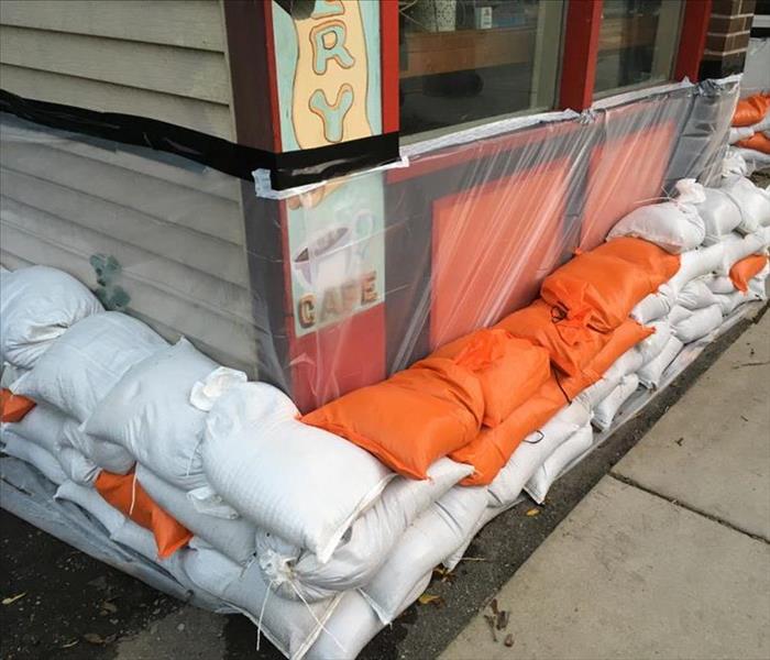 A Business protected from flooding with sand bags and plastic film. 